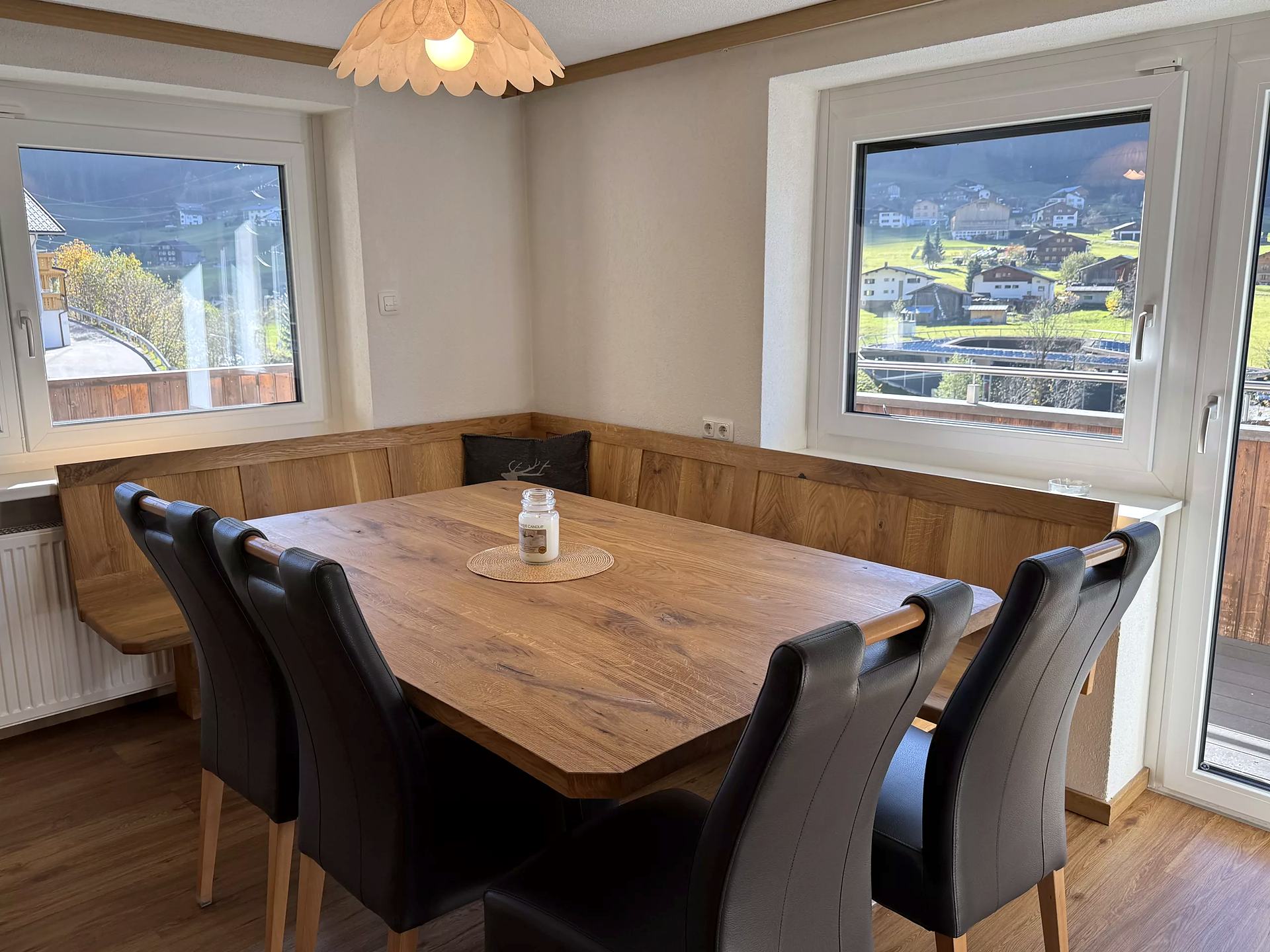 Oak dining nook with panoramic windows overlooking Gaschurn